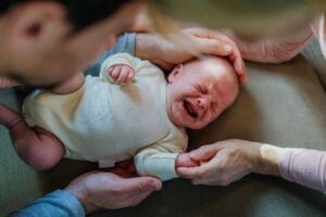 close up,of,parents,cuddling,their,newborn,crying,baby.